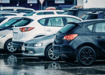 Row of used cars in the rain